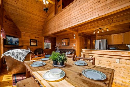 a dining room with a wooden table in a cabin at Great Smoky Mountains Cabin!, Secluded, Pet-Kid Friendly! in Sevierville