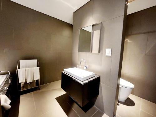 a bathroom with a sink and a toilet at JS Boutique Hotel in Hwaseong