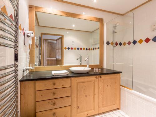 a bathroom with a sink and a mirror at Appartement Saint-Martin-de-Belleville, 4 pièces, 8 personnes - FR-1-461-21 in Saint-Martin-de-Belleville