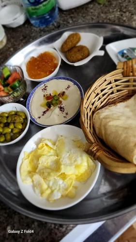 a tray with plates of food on a table at Panorama Jerash HOTEL (2) in Jerash