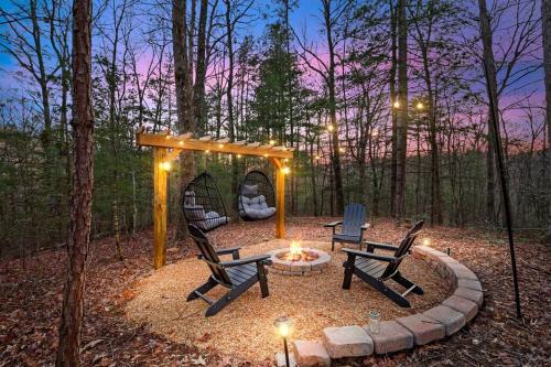 a backyard with two chairs and a fire pit at Upscale 3-Bedroom Oasis Nestled in the Woods in Ellijay