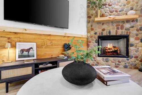 a living room with a fireplace and a tv at Upscale 3-Bedroom Oasis Nestled in the Woods in Ellijay