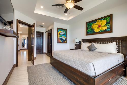 a bedroom with a bed and a ceiling fan at Grand Caribe Belize in San Pedro