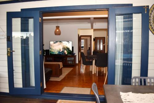 a living room with a blue door and a dining room at Wollongong Beach House Living in Gwynneville