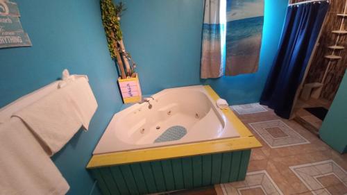 a bath tub in a bathroom with a blue wall at Castaways Villa in Duncans