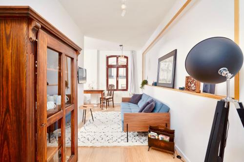 ein Wohnzimmer mit einem blauen Sofa und einem Tisch in der Unterkunft casanando - LaMaison - neu saniert in ruhiger Innenstadtlage in Leipzig