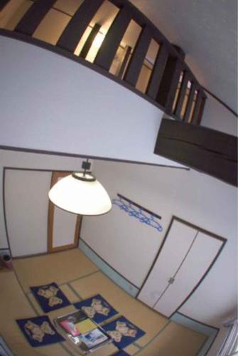 a room with a lamp and a wall with pictures at 歩絵夢の森 Pension Poem no mori in Hakuba