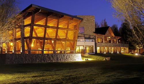 a large building with a fountain in front of it at Hotel Posada Los Alamos in El Calafate
