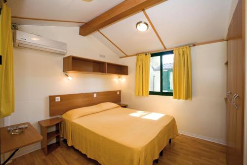 a bedroom with a bed and a window at Camping Villaggio Santa Maria Di Leuca in Gagliano del Capo