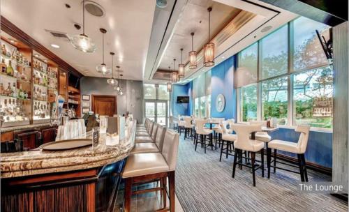 a restaurant with a bar and tables and chairs at Stunning Balcony Strip View MGM Signature * Free Valet in Las Vegas