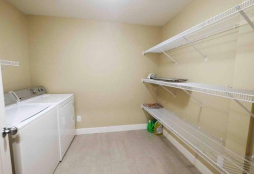 een wasruimte met een wasmachine en een wasmachine bij Cozy Home Nestled in Burke Mountain. in Coquitlam