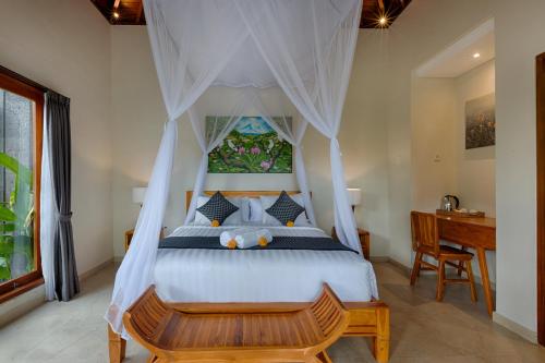 a bedroom with a bed with a canopy at Kelusa Hill in Ubud