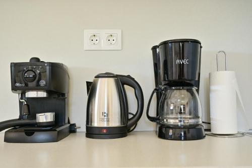 a coffeemaker and a coffee maker on a counter at To Spiti Tou Papa Sto Vouno in Kamilari