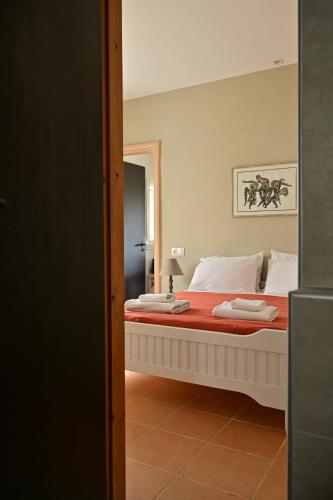 a bedroom with a large bed with a mirror at To Spiti Tou Papa Sto Vouno in Kamilari