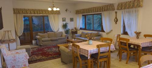 a living room with two tables and a couch at Arnica Montana in Arieşeni