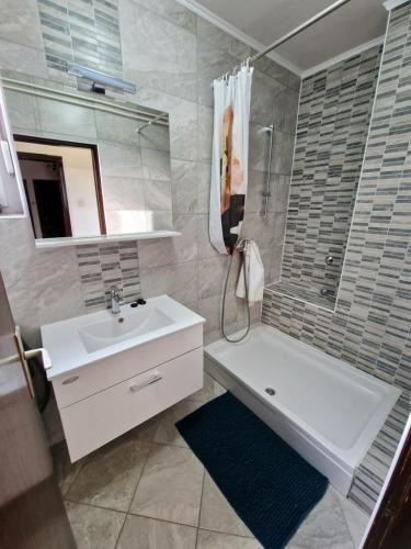a bathroom with a sink and a tub and a shower at Stan na dan Koprivnica-Comfort in Koprivnica