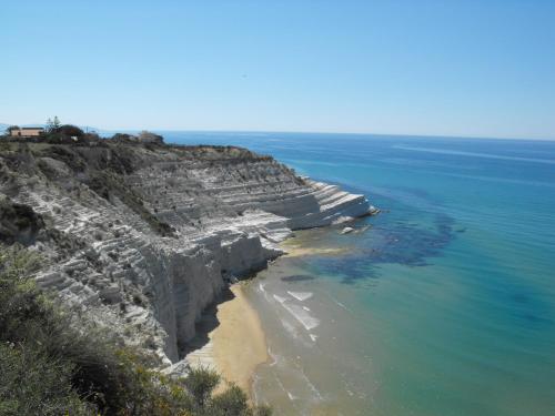 an aerial view of a rocky cliff next to the ocean at Appartamento Valle dei Templi in Realmonte