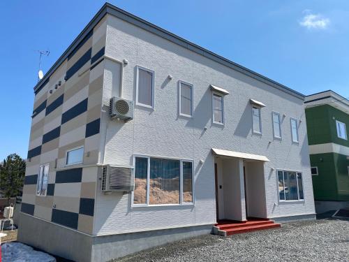 a building with a checkerboard pattern on it at AOI in Furano
