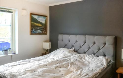 an unmade bed in a bedroom next to a window at Cozy Apartment In Sigtuna With Wifi in Sigtuna