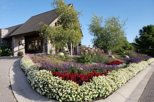 a garden of flowers in front of a building at Turret House at Birchwood in Harbor Springs