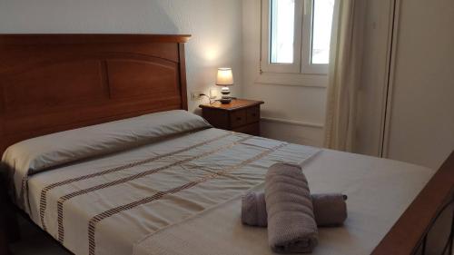 a bedroom with a bed with two towels on it at Don Paco - Front Line Of The Beach Apartment in Roquetas de Mar