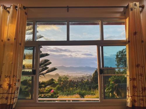a window with a view of a mountain view at Phuyafahsai The Resort Khao Kho in Khao Kho