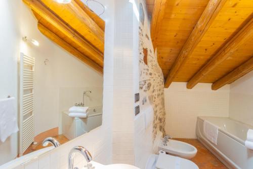 a bathroom with a white toilet and a sink at Antiche Mura Como by Rent All Como in Como