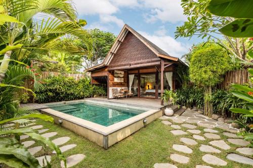 a house with a swimming pool in the middle of a garden at Rimba Villas Gili Air in Gili Islands