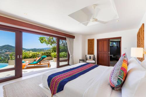 a bedroom with a large bed and a balcony at Panorama Summit - Private Pool with Sunset View in Plai Laem