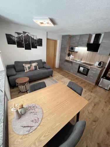 a living room with a table and a couch at Apart Mark in Tarrenz