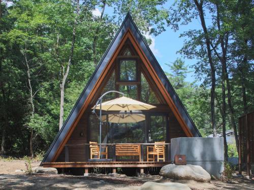 a cabin with an umbrella in the woods at Villa Yoshino - Vacation STAY 01536v in Azumino