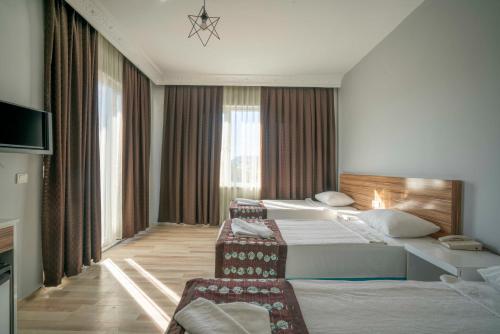 a hotel room with a large bed and a chair at Aslan Corner Hotel in Alanya