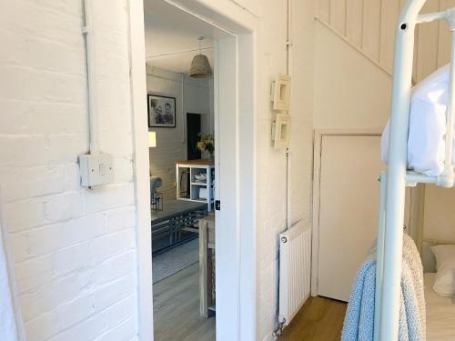 a bedroom with a door leading into a room at The Coach House - Bournemouth in Bournemouth