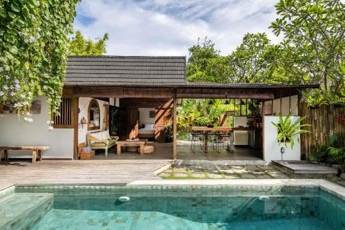 a house with a swimming pool and a pavilion at Rimba Villas Gili Air in Gili Islands