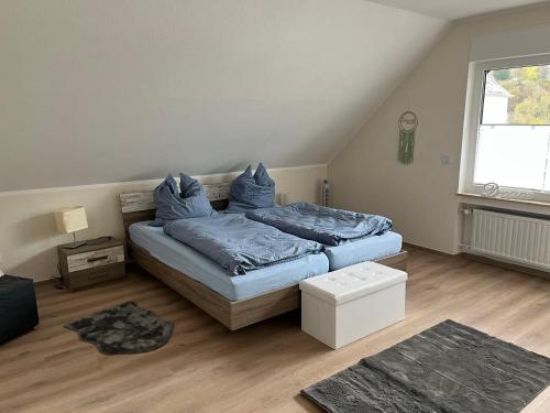 a bedroom with two beds with blue pillows at Ferienwohnung Christa in Bullay