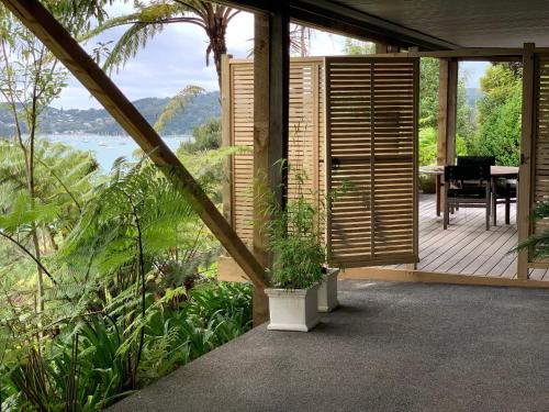 a porch of a house with a table and a view at Sea Veiws Kaha Place in Russell