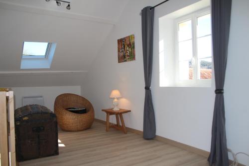a room with a window and a chair and a table at GITE DU MOULIN in Arudy