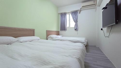 Postel nebo postele na pokoji v ubytování Fengchia Bichon B&B