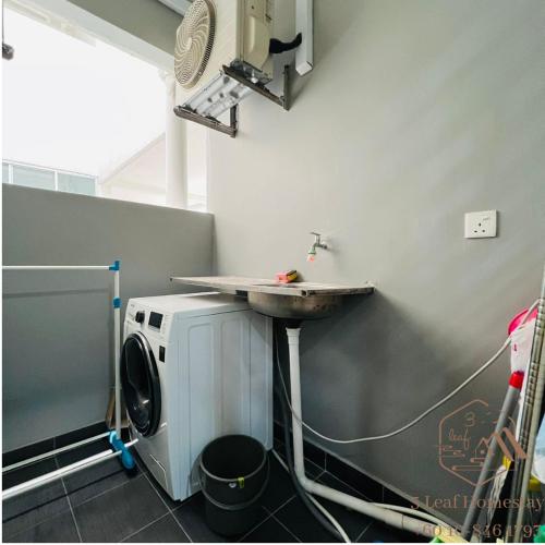 a bathroom with a sink and a washing machine at KULAI IOI MALL D'Putra Suites Near JPO Senai Airport in Kampong Saleng