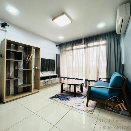 a living room with a blue couch and a tv at KULAI IOI MALL D'Putra Suites Near JPO Senai Airport in Kampong Saleng