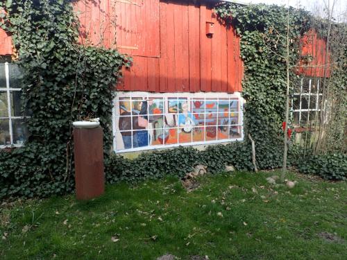 a house with a mosaic window on the side of it at Gemütliche Ferienwohnung in hirschreicher Umgebung in Jasnitz