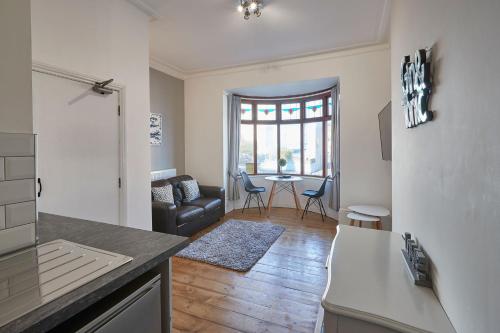 a kitchen and living room with a couch and a table at Apartment 2, Khyber Lodge Apartment Whitby in Whitby