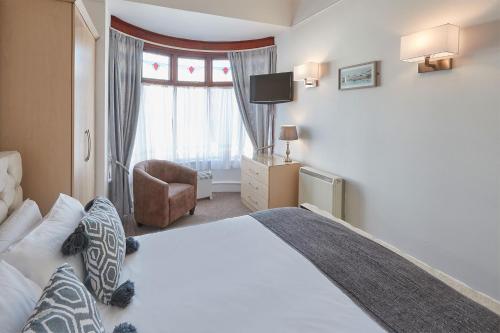 um quarto com uma cama grande e uma janela em Apartment 3, Khyber Lodge Apartments Whitby em Whitby
