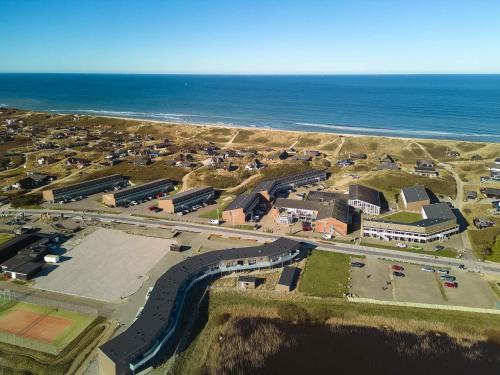 an aerial view of a parking lot next to the ocean at 6 person holiday home on a holiday park in Ringk bing in Ringkøbing