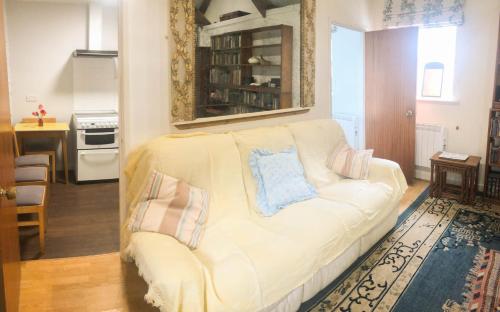 a living room with a white couch with pillows on it at Ty Cambria in Carmarthen