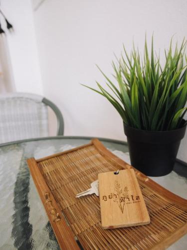 a wooden tray on a glass table with a plant at Phuyafahsai The Resort Khao Kho in Khao Kho