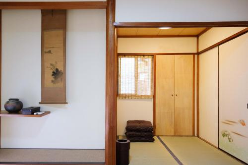 an entrance to a room with a door and a window at 伊豆の宿　静海 in Ito