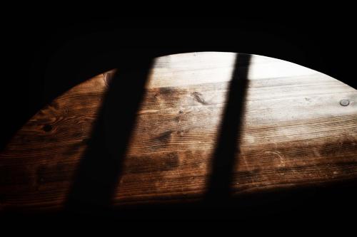 a shadow of a wooden table in a dark room at 伊豆の宿　静海 in Ito