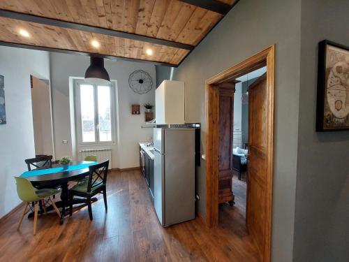 a kitchen and dining room with a table and a refrigerator at Savieri Home in Florence in Florence