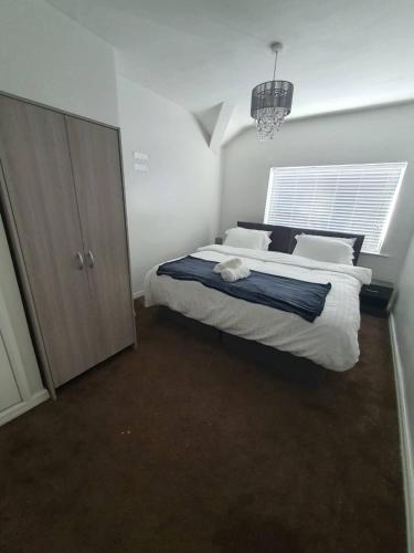 a bedroom with a large bed and a window at Private RoomB Middleton Manchester in Middleton